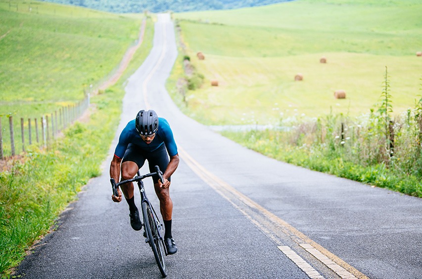 Road rider climbing a hill.