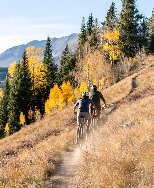 mountain bikers riding uphill on electric mountain bikes 