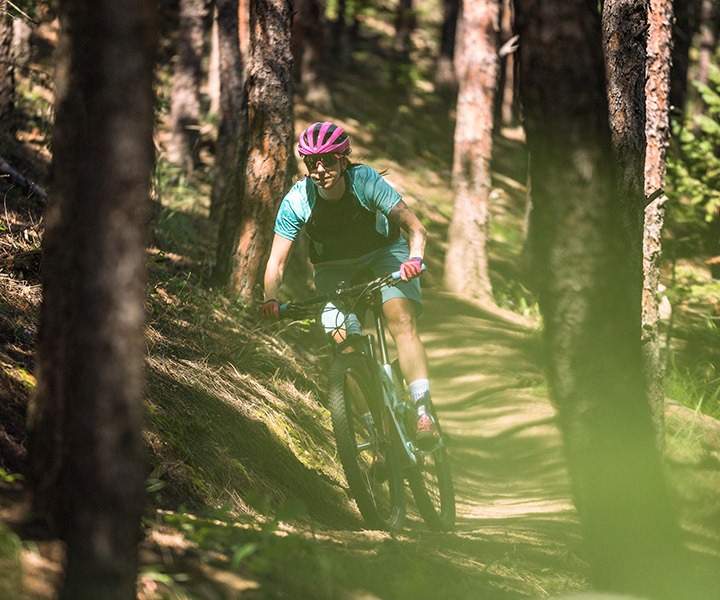 person riding a mountain bike on a trail