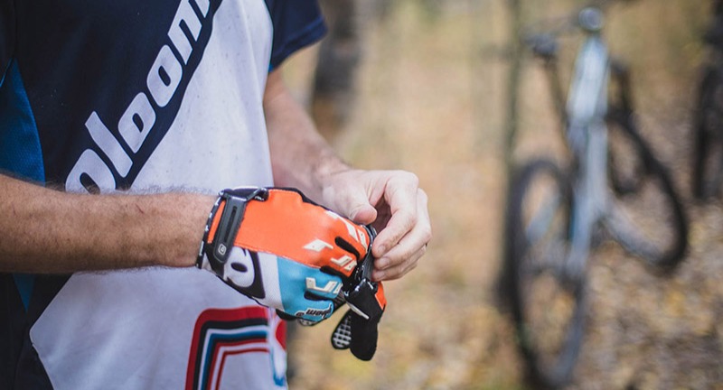 Cyclist putting gloves on