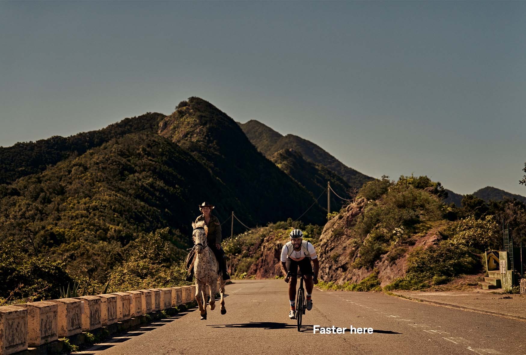 An image of someone riding a Cannondale SuperSix EVO next to a racing horse