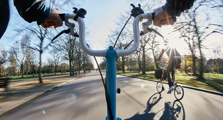 A couple of cyclists riding folding bikes.