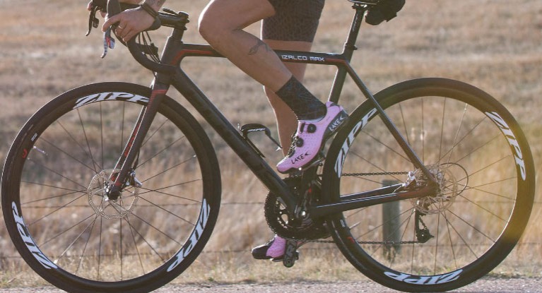 Woman riding road bike with road shoes