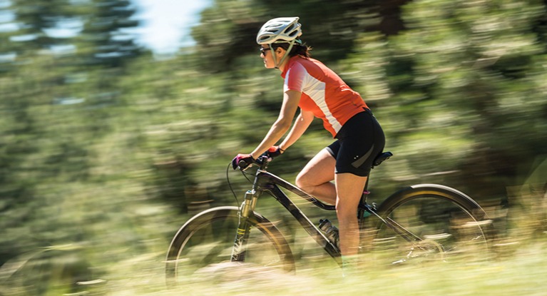 A woman riding a mountain bike.