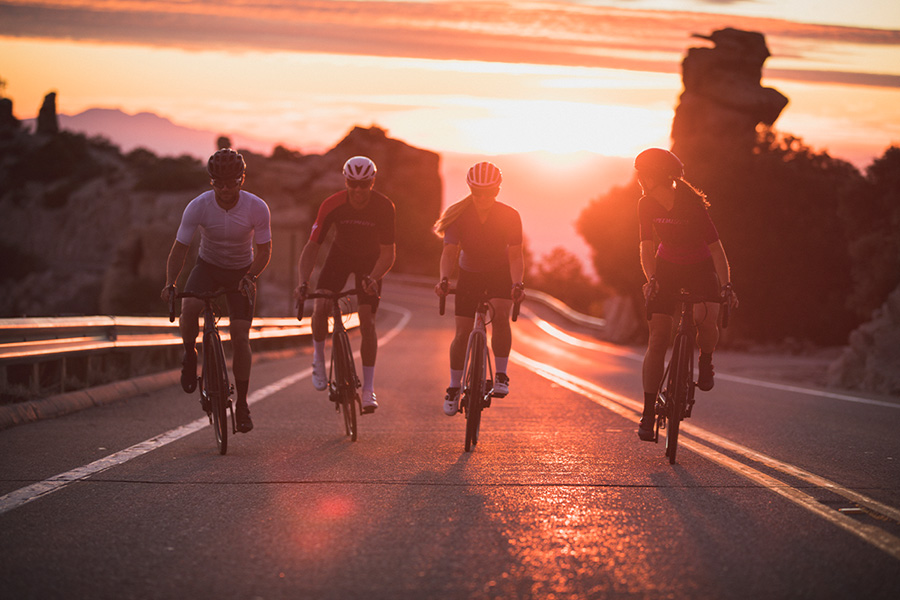 road cyclists with sunset