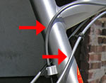 Plastic beats metal this time. Protect your frame from cable rub.