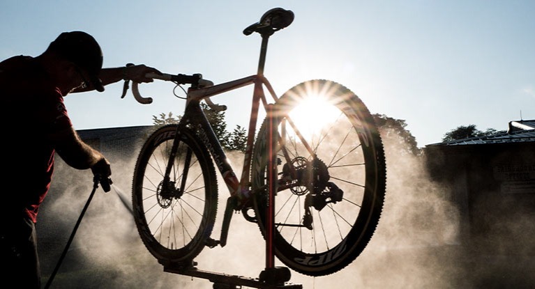 Man Powerwashing a Bike