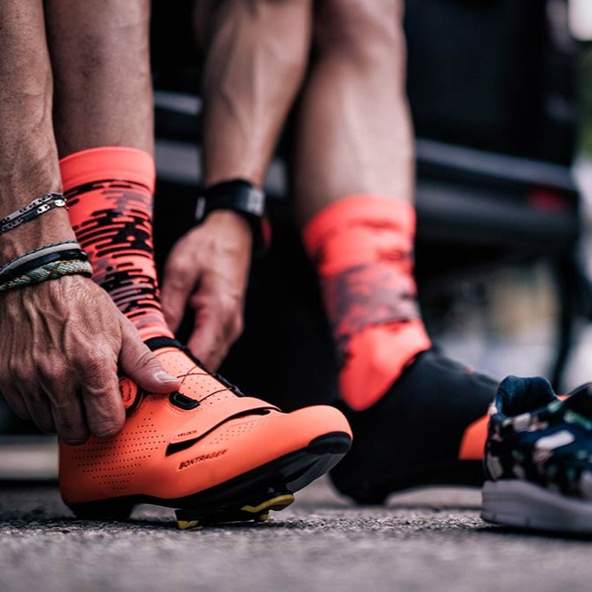 Rider putting on cycling shoes