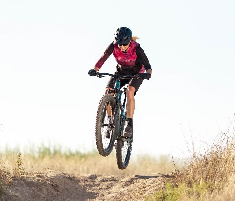 Image of a person riding and jumping their mountain bike