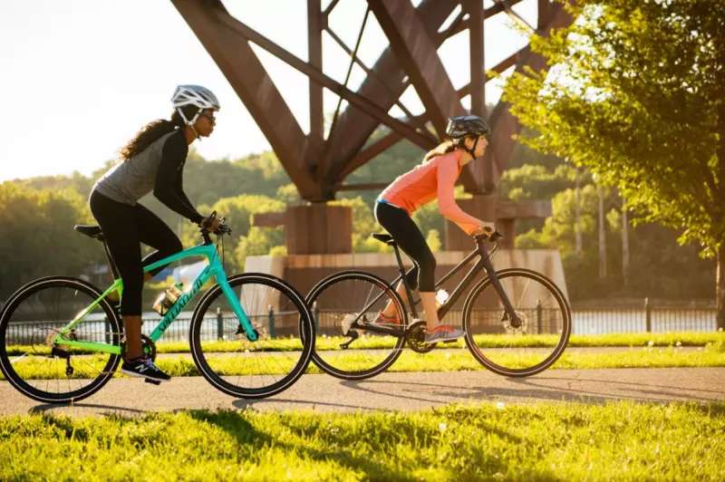 2 Bike Riders on Specialized Sirrus Bikes riding on a trail