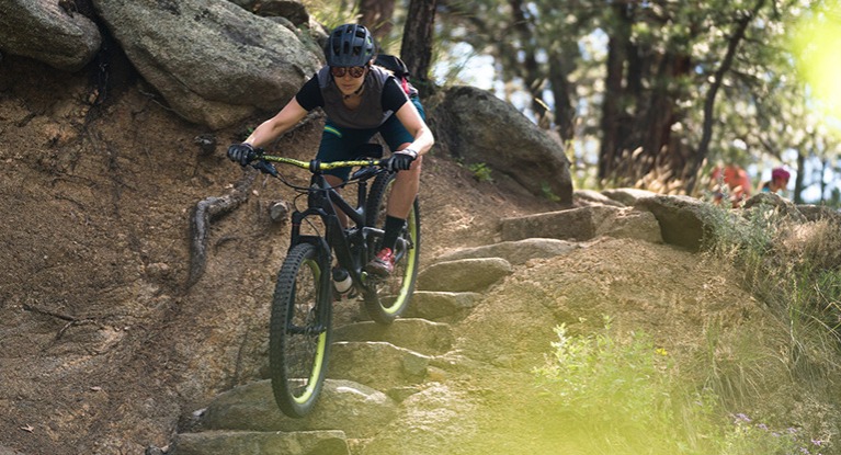 A woman riding a full suspension mountain bike