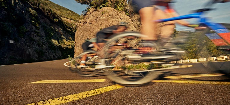 A bike rider riding a Cannondale Synapse Endurance Road Bike on a Trail