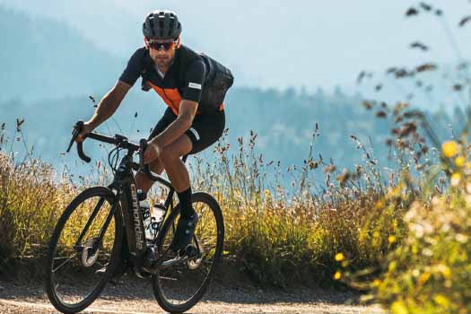 A bike rider riding a Cannondale Synapse Endurance Road Bike on a Trail