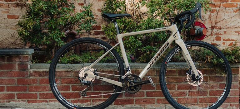 A Jamis Renegade bike leaning against a brick wall