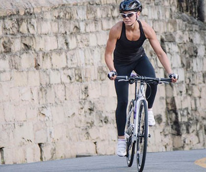 Woman Cyclist riding a Liv Bicycle with Flat Handlebars