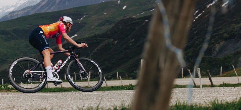 A man riding a Cannondale Synapse bike on a trail