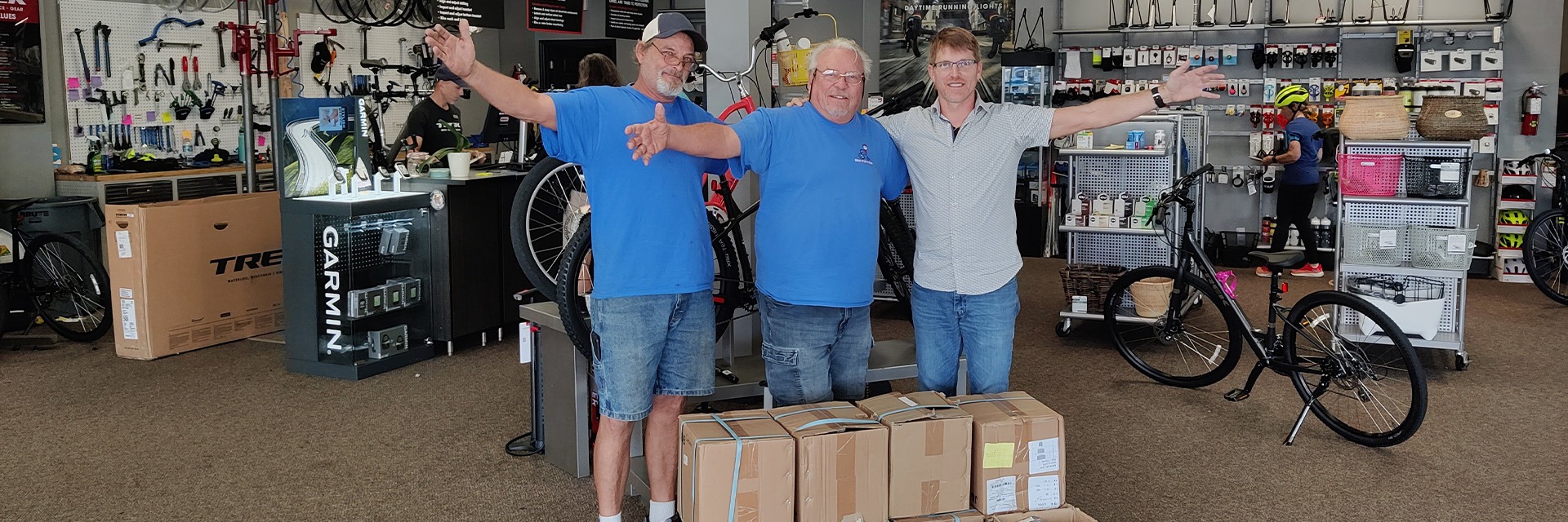 Mark Zirzow, Marketing Manager for Trek Bicycle Stores of Florida (Right) meets with Skip Riffle from Bikes for Tykes (Center) and John, a bicycle technician, (Left) to deliver the tube donation at our South Naples location.