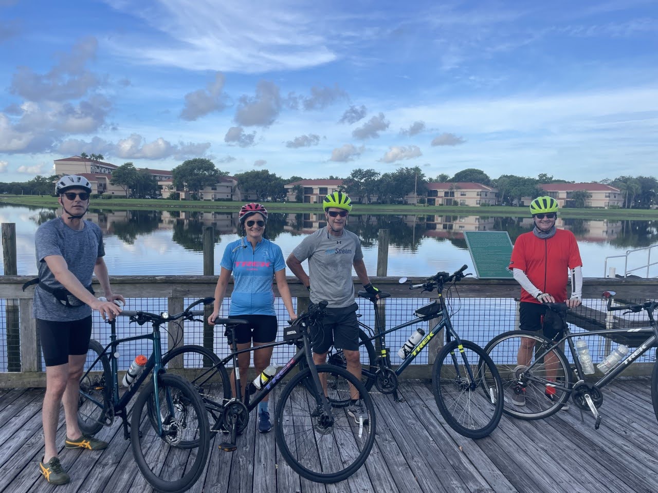 Four people pose with their Trek bikes overlooking intertidal waters in Coconut Creek Florida