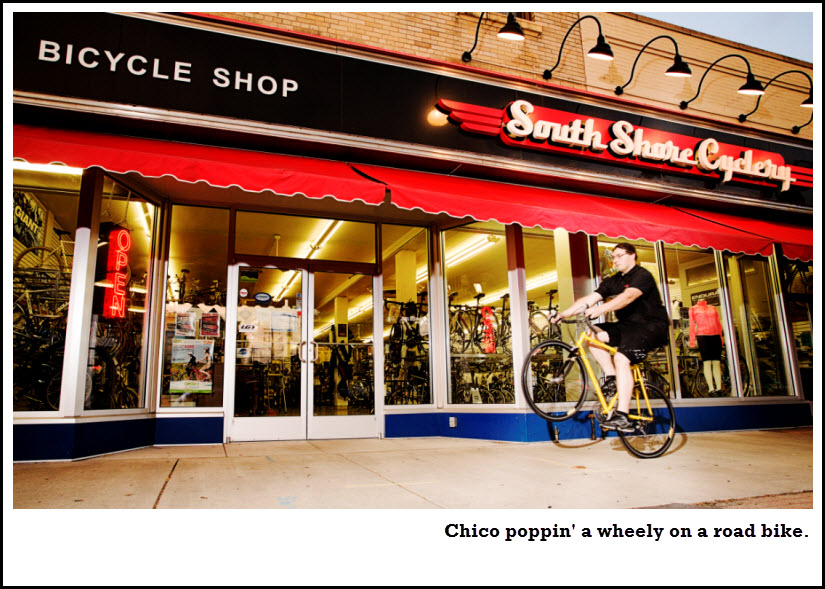 Chico riding wheelie in front of store