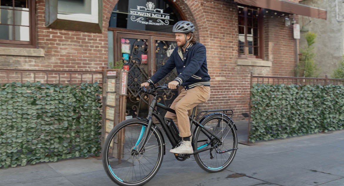 person riding an electric bike through town