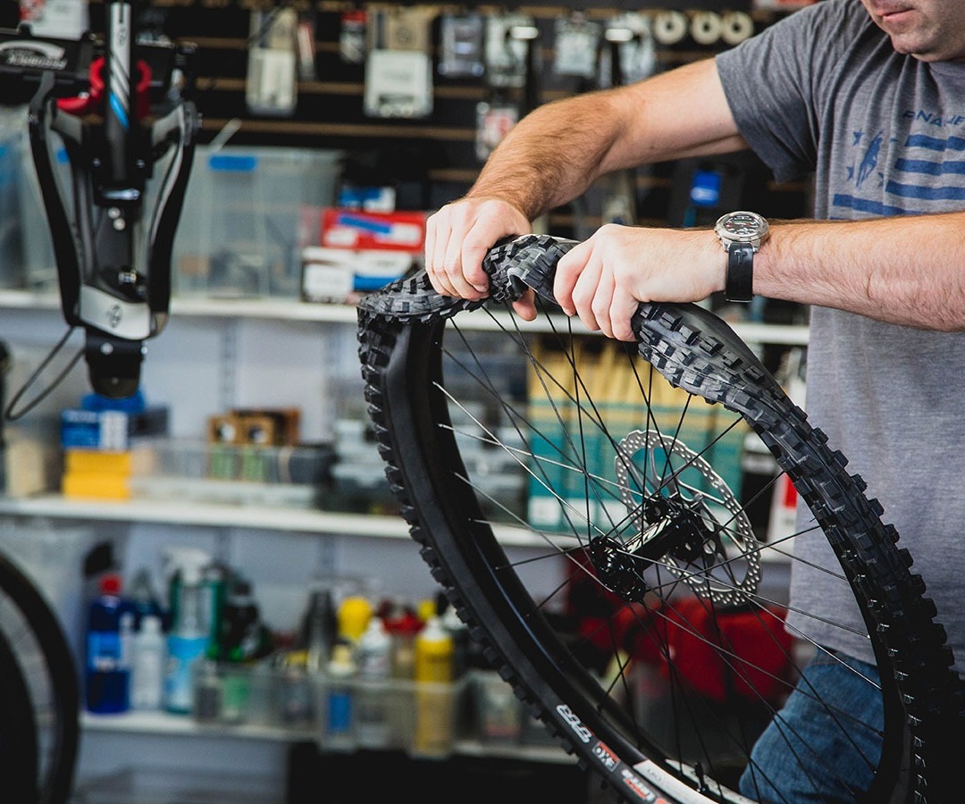 Bike Technician working on a wheel