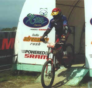 Person racing on a downhill mountain bike