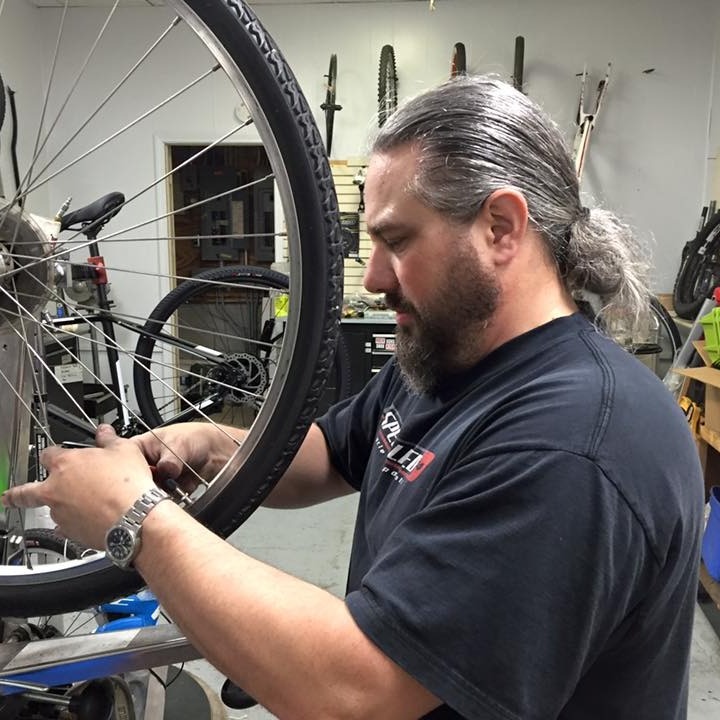 Bike mechanic working on a bike in the bike shop