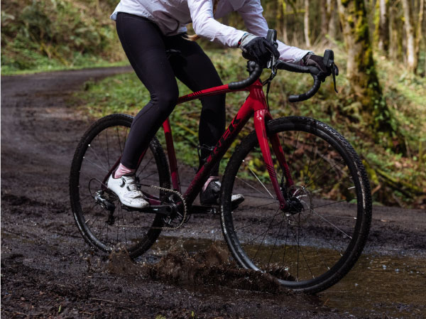 2020 trek crockett gravel bike riding through puddle on dirt road
