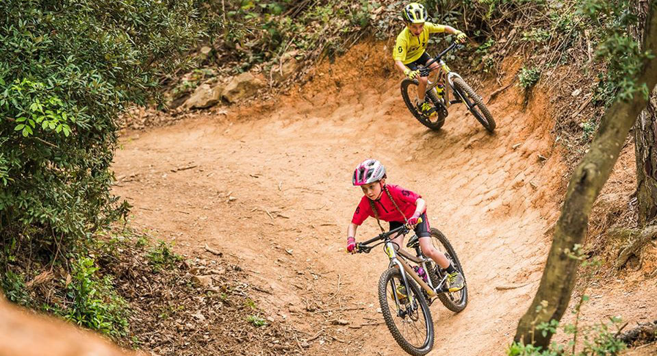 Girl and boy riding mountain bikes on a trail