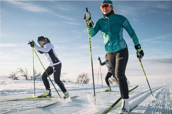 women dressed for cross country skiing in hat, sunglasses, and layers