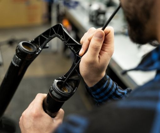 Mechanic working on bike suspension