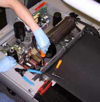 Image of a technician repairing a treadmill