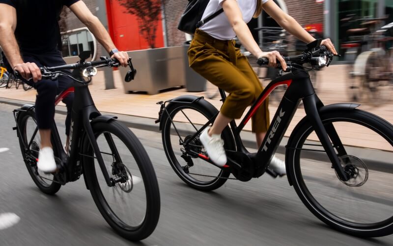 A couple riding Trek ebikes