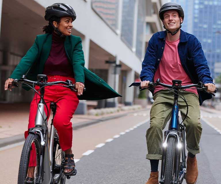 Two people riding hybrid bikes