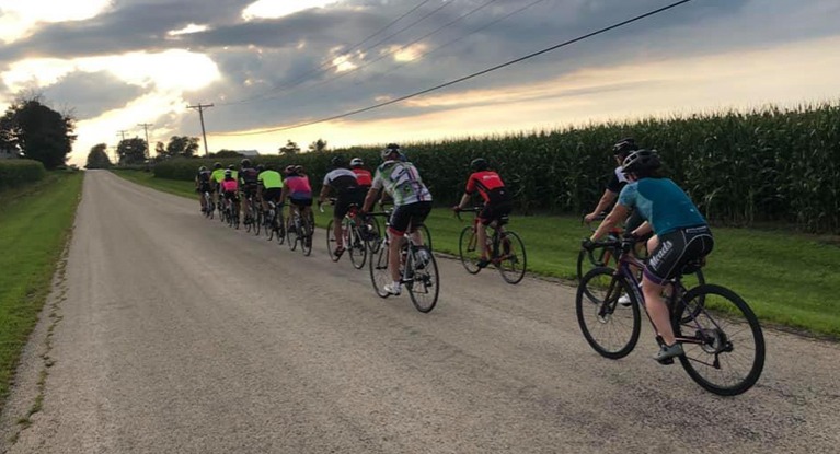 group of riders riding on a gravel road