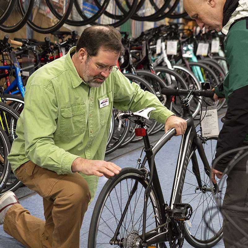 Sales Associate pointing out tires on a bike