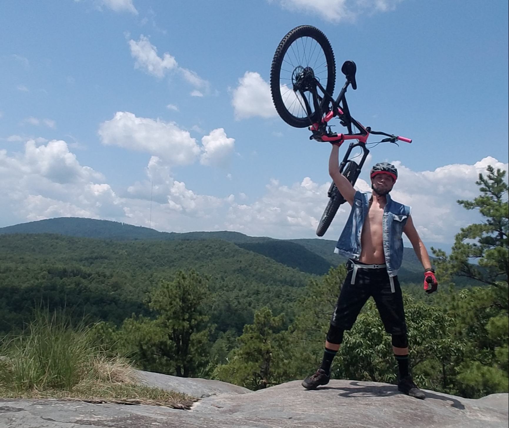 Chris Crane holding up mountain bike