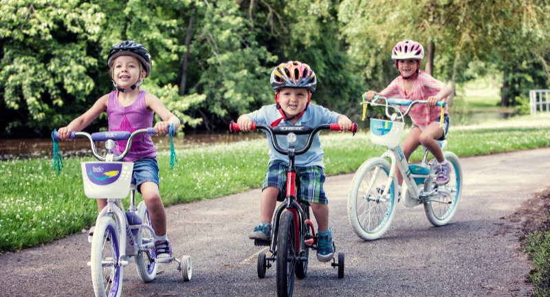 three kids riding bikes