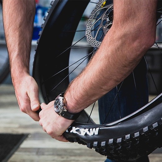 mechanic changing a mountain bike tire