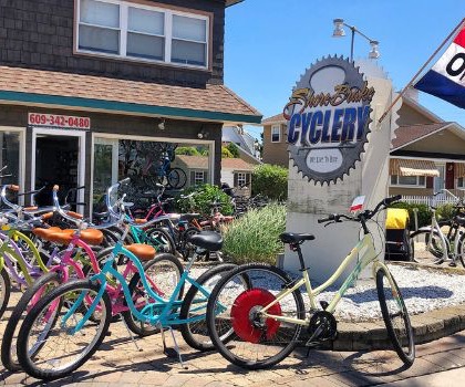 Photo of front of Shore Brake Cyclery Bike Shop with Logo sign and bikes on display outside