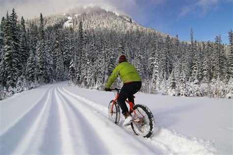 person riding mountain bike in the snow