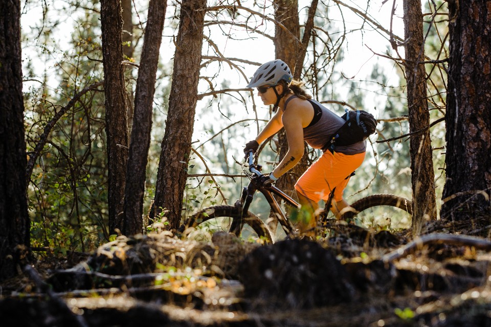 Image of a person mountain biking in the woods