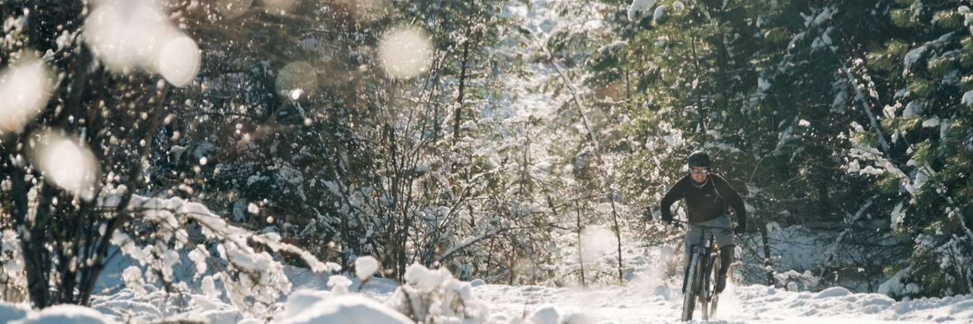 Image of a person riding their mountain bike in the snow