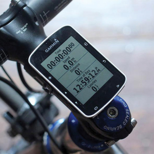 A close-up of a GPS attached to a bike's handlebar.