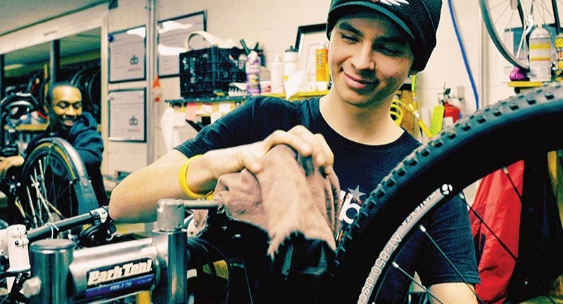 Men work on bikes in the service department