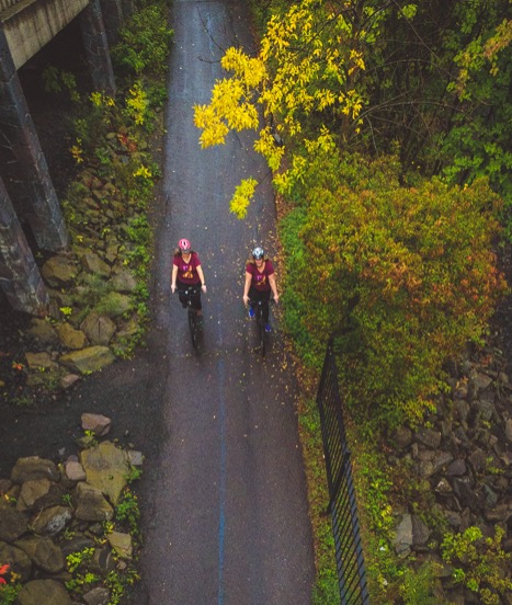Two Duluthian women ride Momentum LaFree bikes on a trail