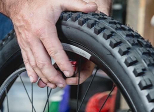 Bicycle tech filling up a tire