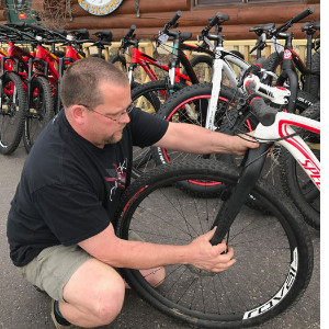 Chris checking a quick release wheel on a bike