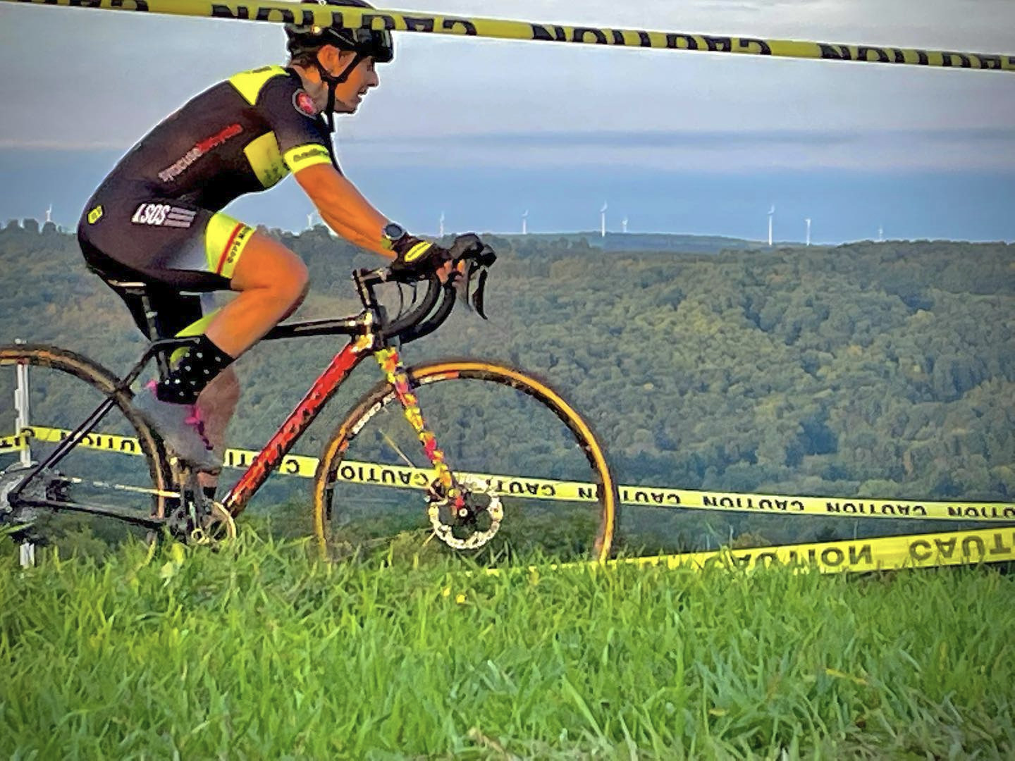 Cyclocross racer running over an obstacle.