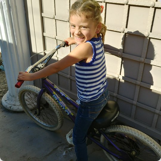 little girl on purple kids bike